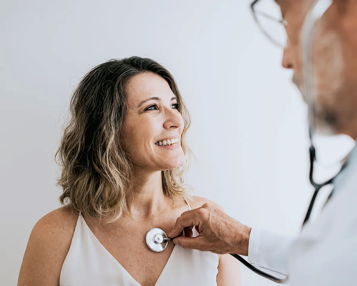Doctor using a stethoscope on a woman