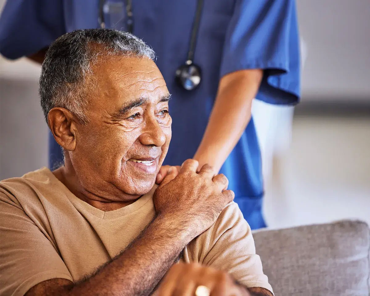 Man with doctor's hand on shoulder