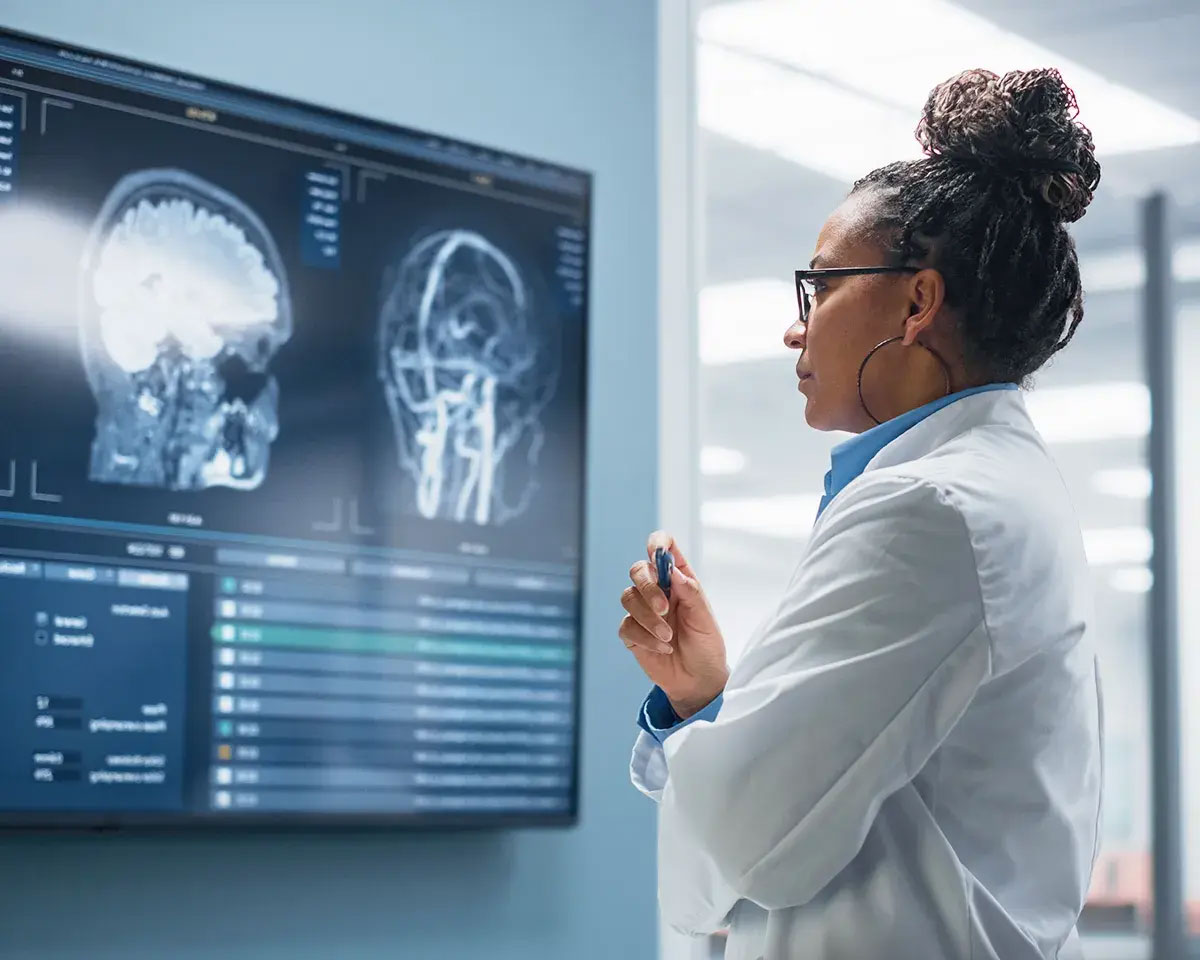 Doctor looking at xrays on a large monitor