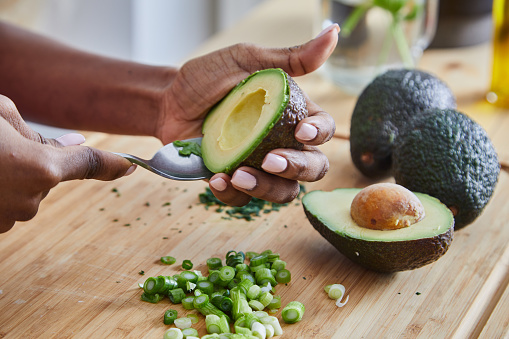 Person cutting out an avocado