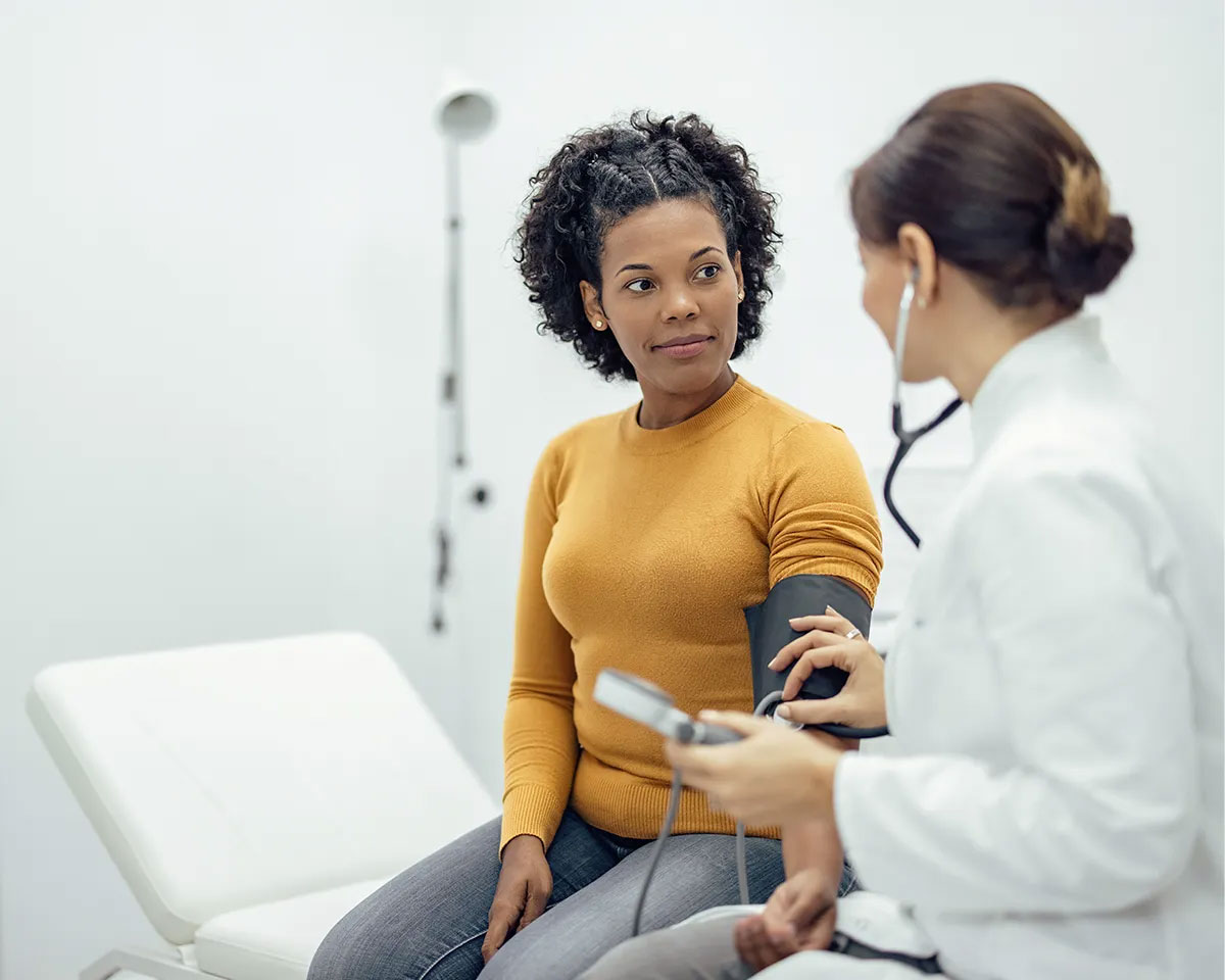 Woman getting her blood pressure measured by a doctor