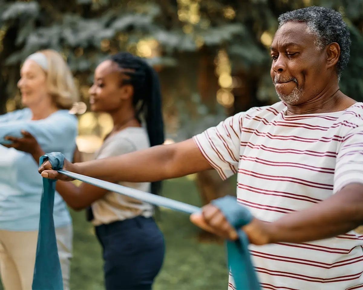 People outside using exercise bands