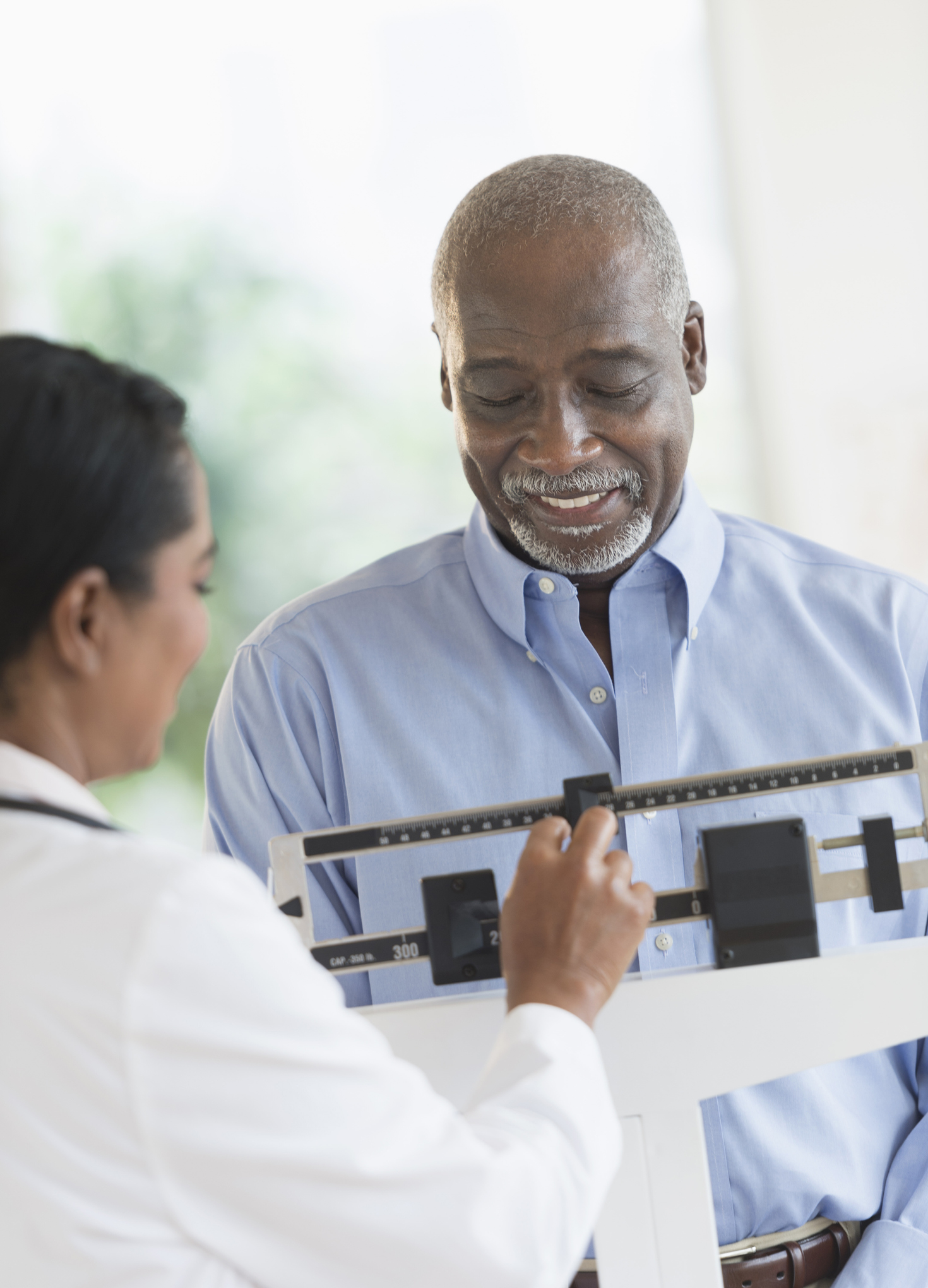 Doctor weighing man