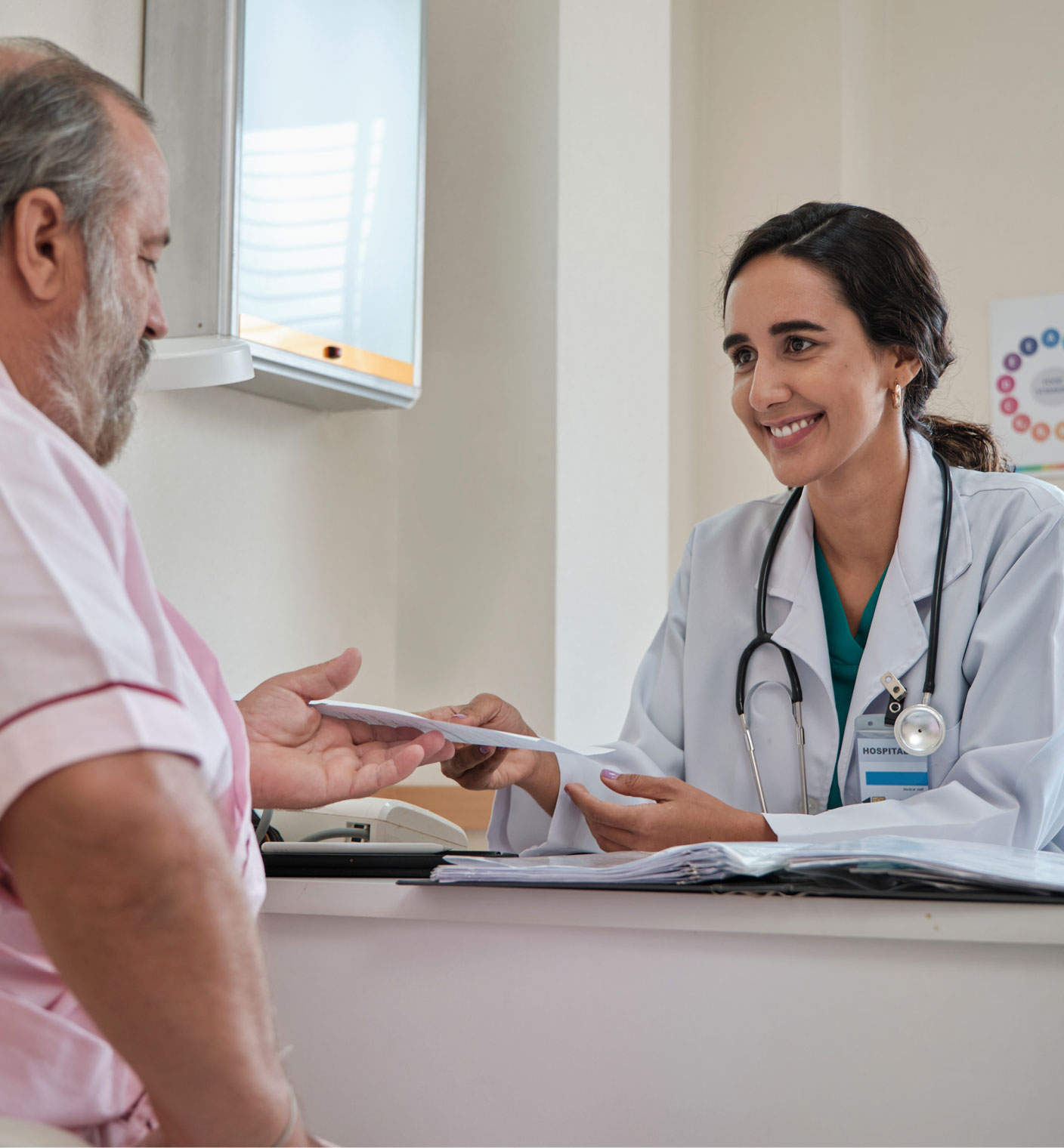 Man at a desk talking to a doctor
