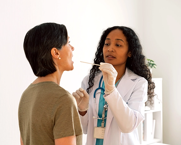 Doctor using a swab to examine a patient