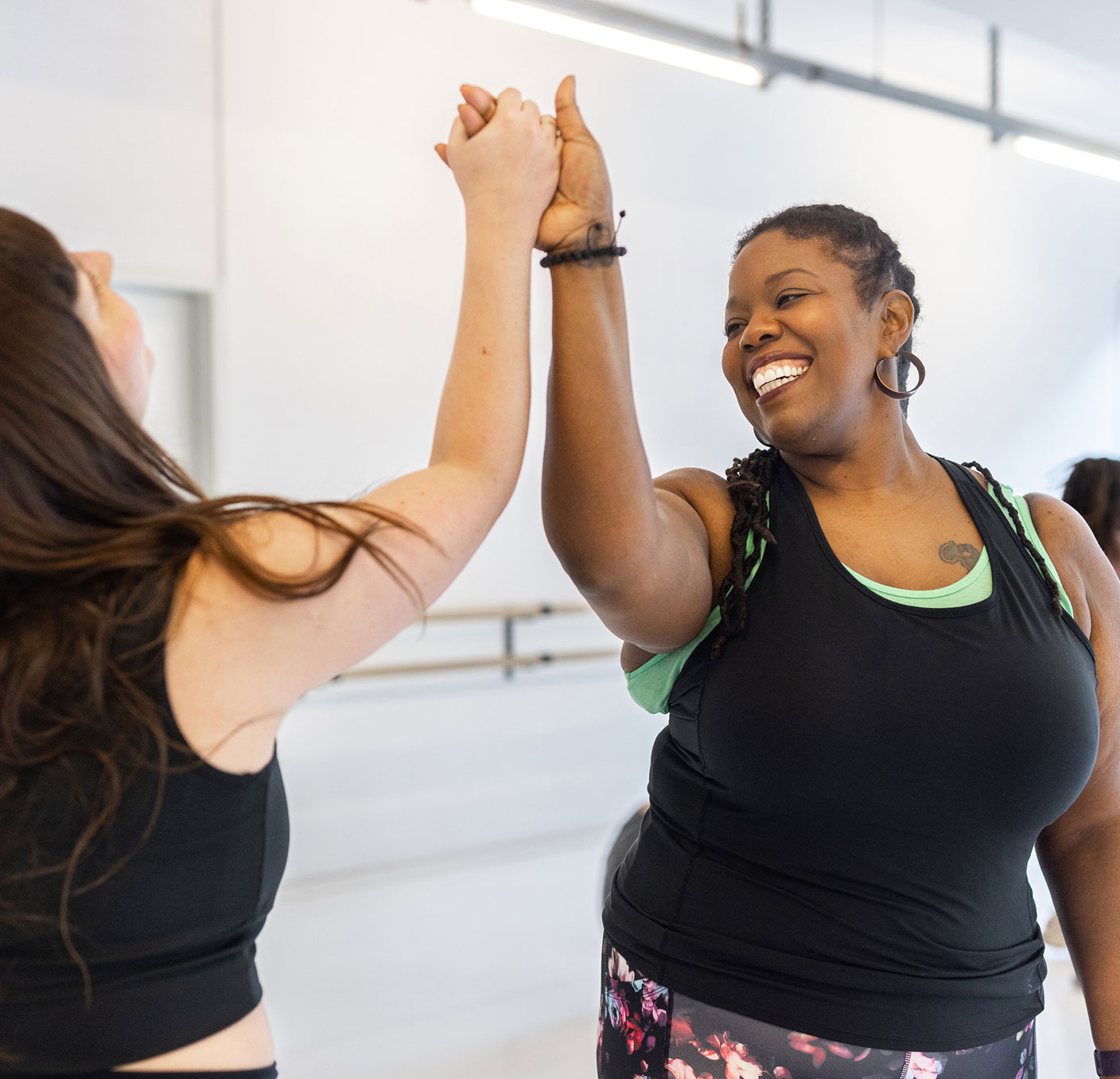 Two women giving high fives to each other