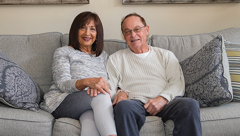 Robert Malon and wife sitting on a couch