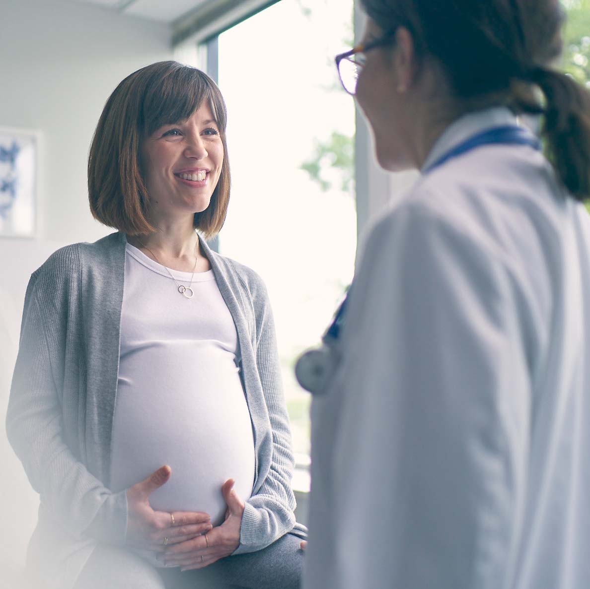 Pregnant woman talking to doctor