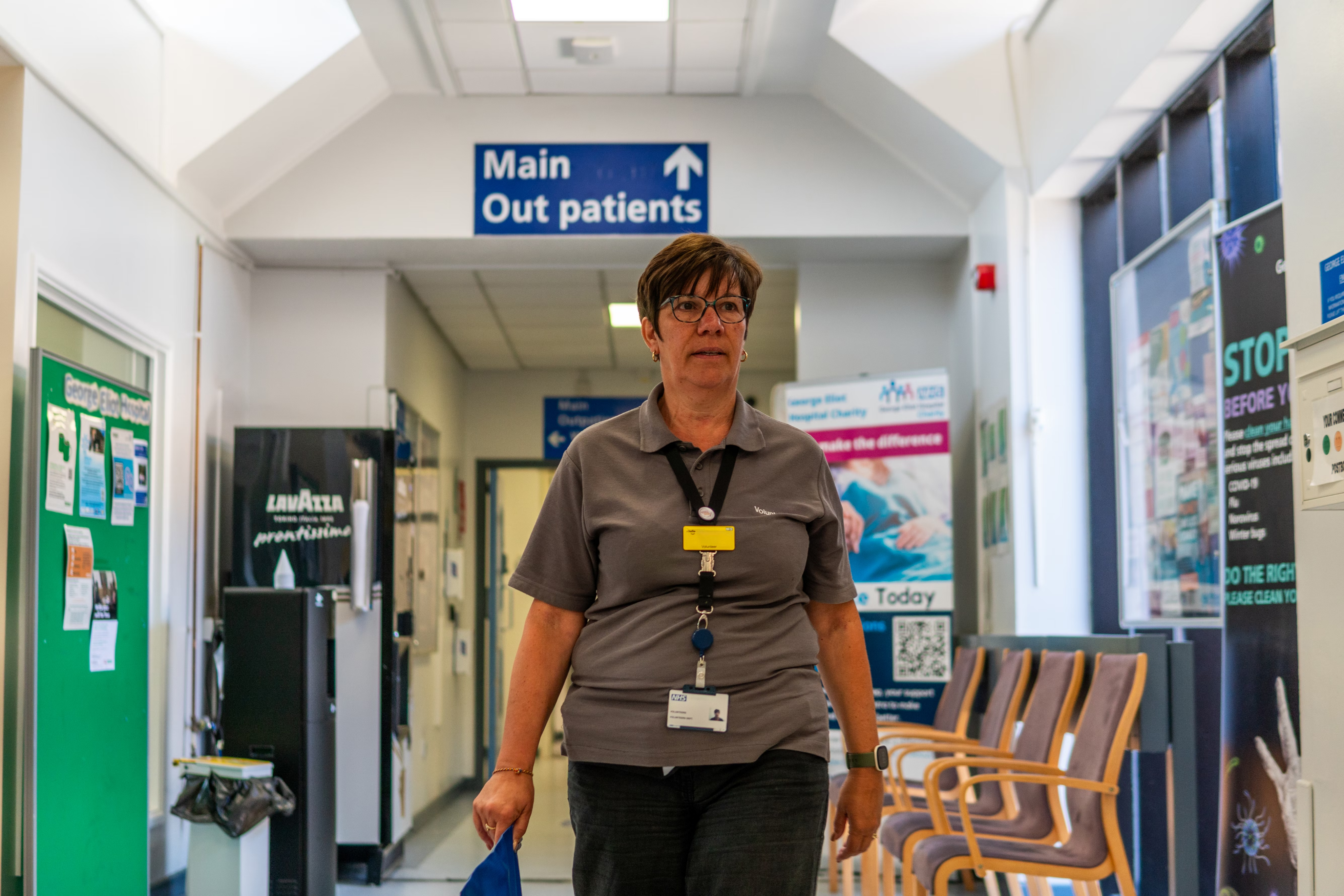 Person walking through a hospital hallway.