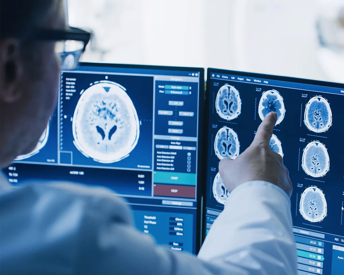 Doctor looking at monitors of medical scans