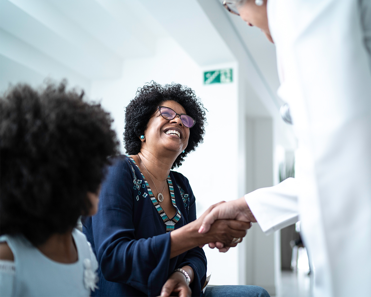 Woman shaking hands with a doctor
