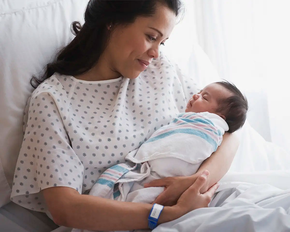 Mother holding infant.