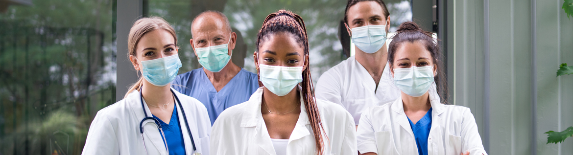 Five physicians wearing masks