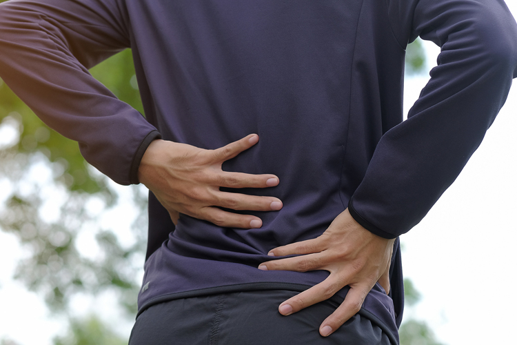 Man holding his back