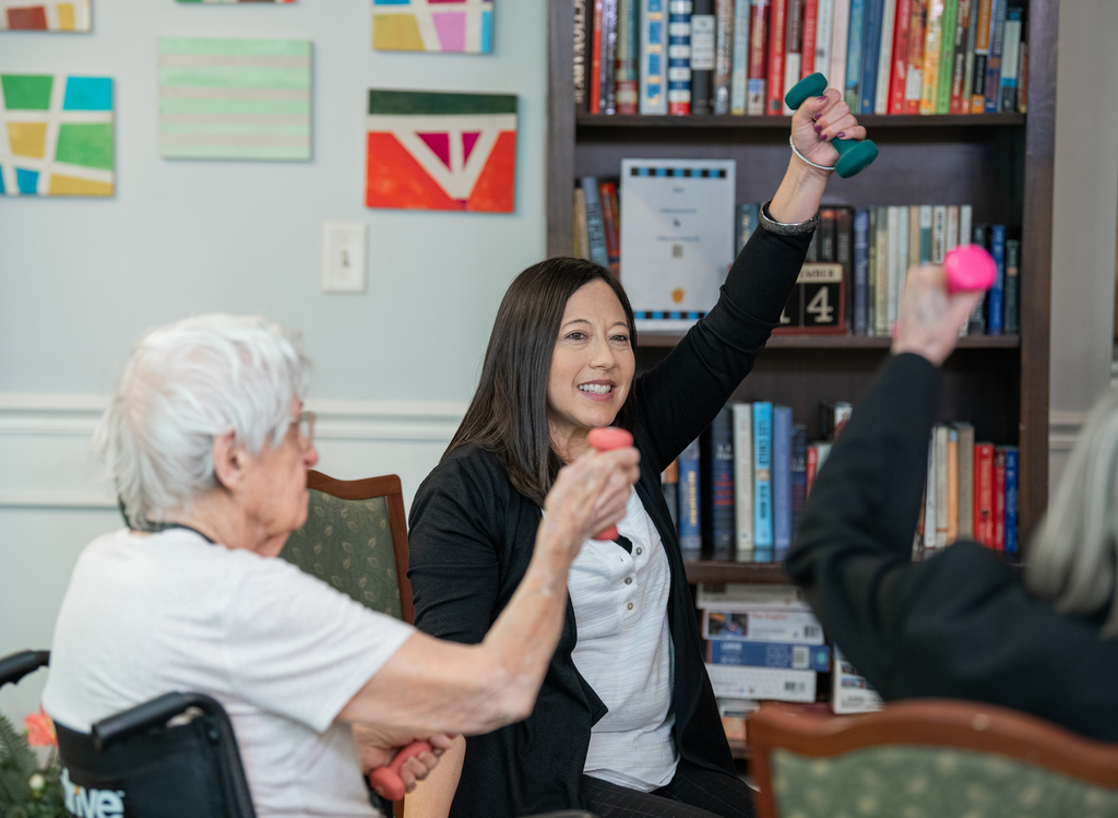 volunteer lady exercising with older lady