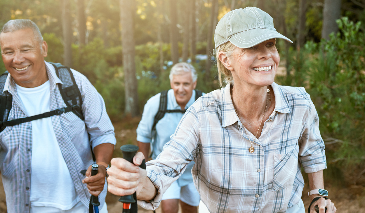 3 people hiking through the woods