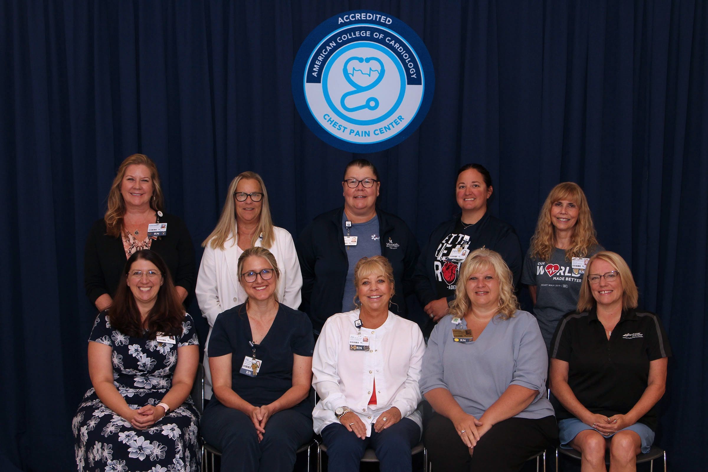  American College of Cardiology Chest Pain Center team of 10 seated with surrounding black background