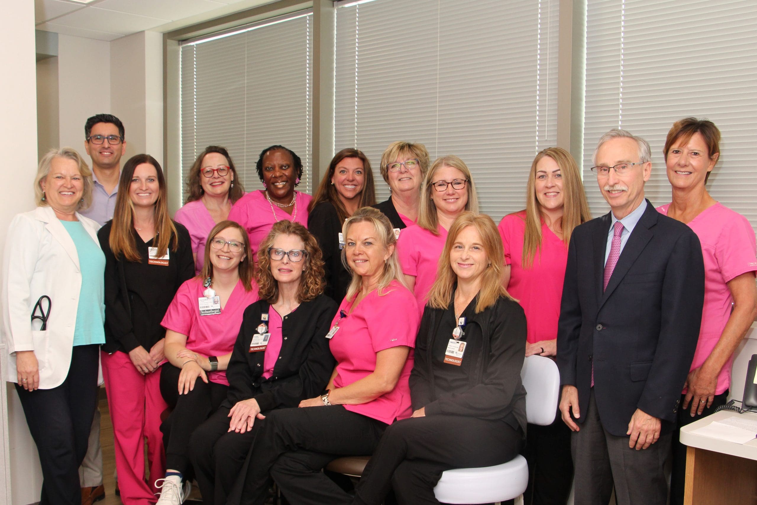Alton Memorial Hospital Harold & Dixie LePere Breast Center group of 15 wearing mainly black suits or pink scrubs