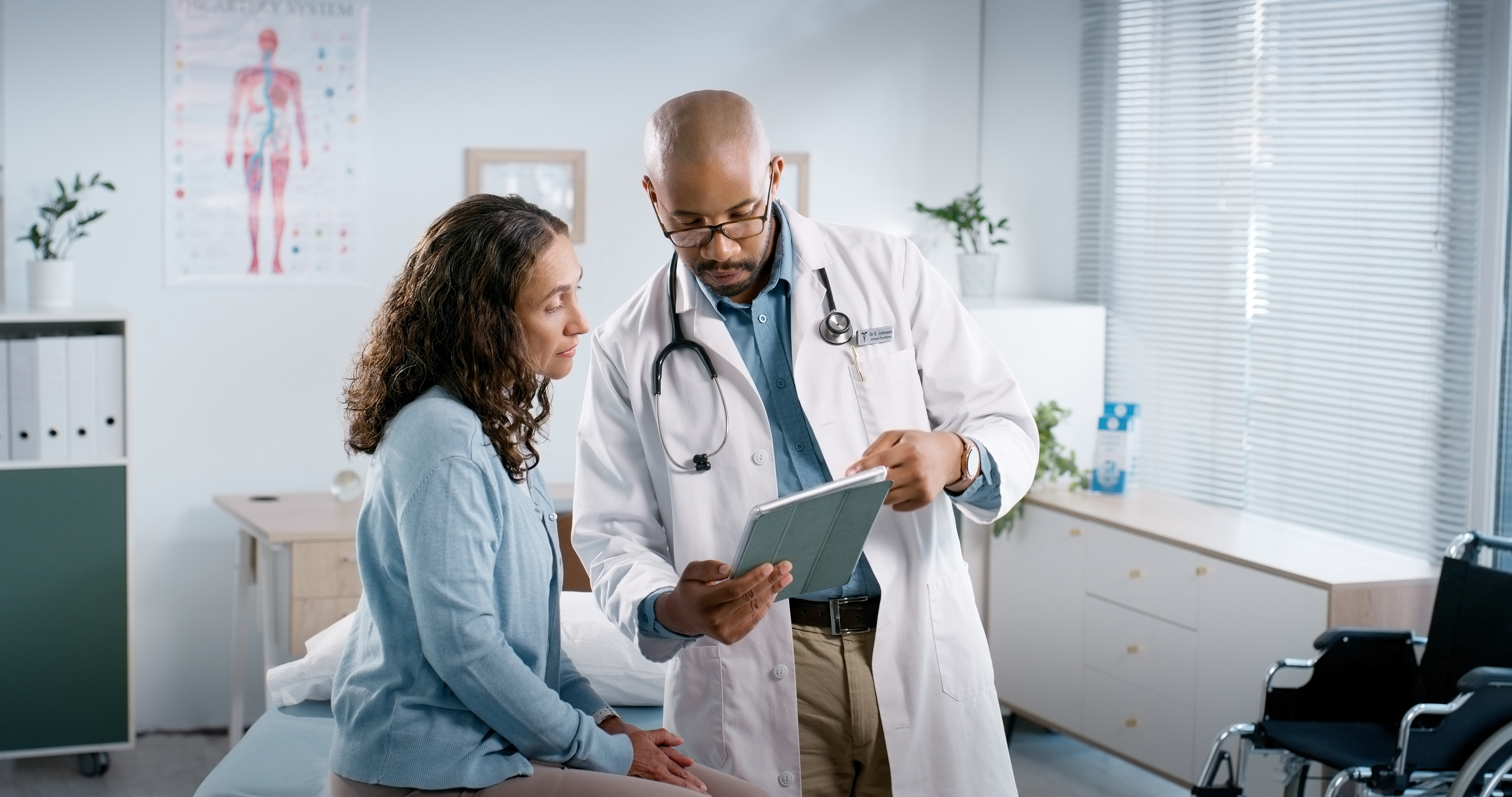 A provider discussing information with a patient in a clinical setting