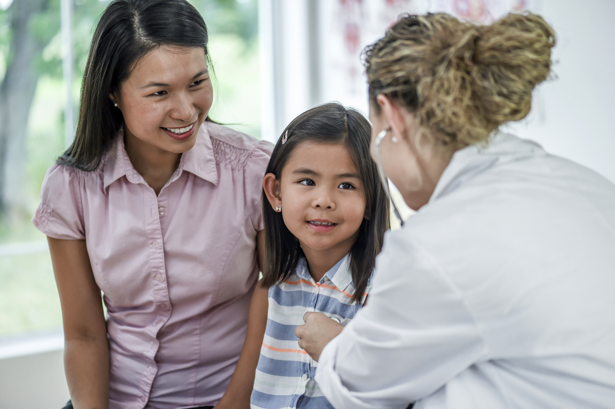 A mother and daughter being seen by a provider