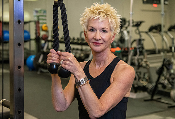 Patient Lena Horne at a gym using exercise equipment