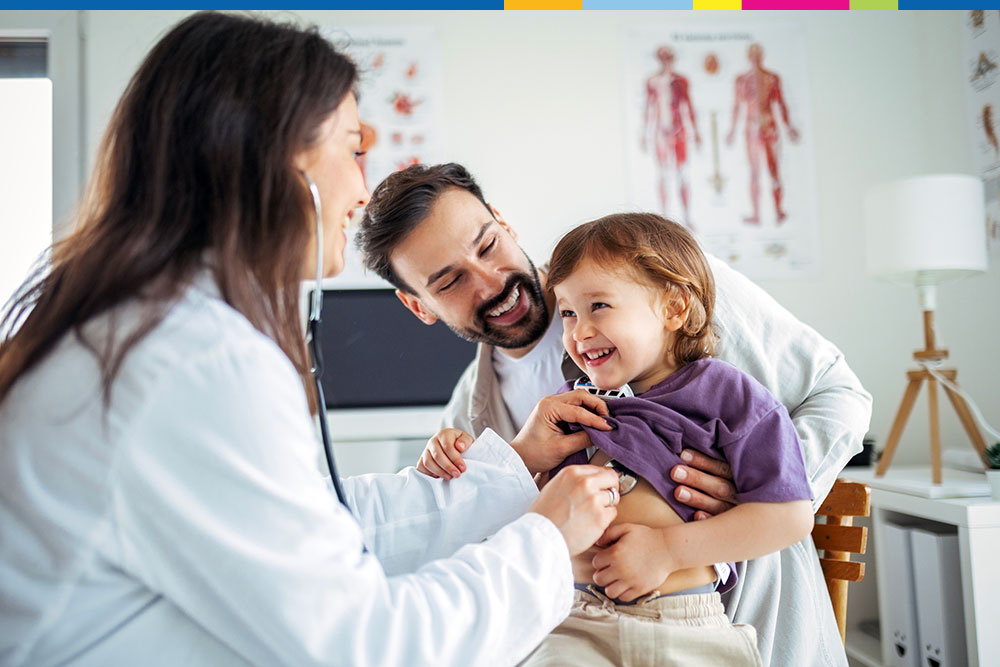 Child being examined by a doctor while the father is holding the child