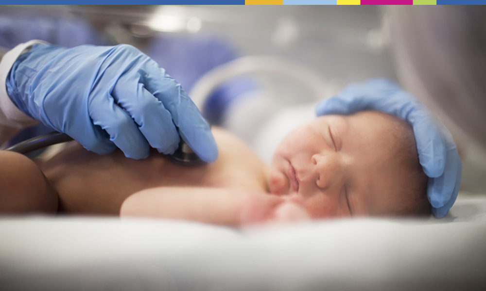 Baby examined with a stethoscope while laying down