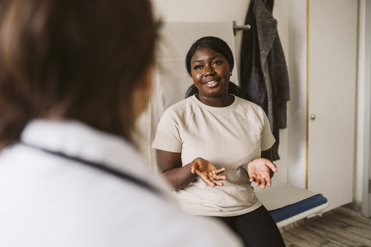 Woman sitting and speaking with her provider