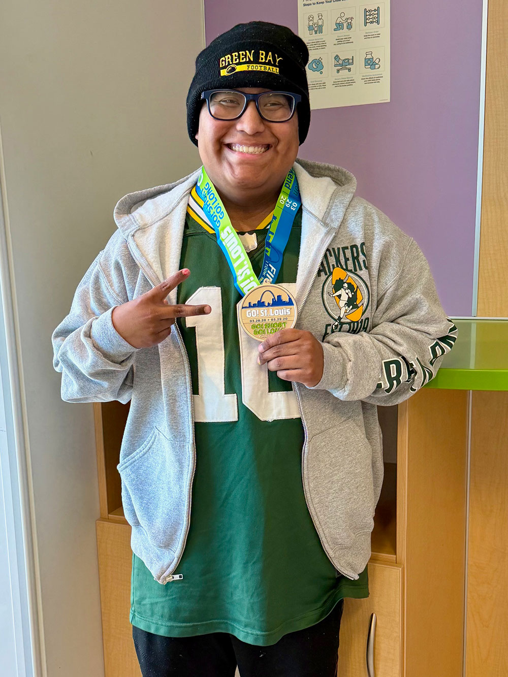 Jaden holding a medal around his neck and smiling