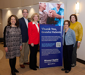  Members of the Missouri Baptist Healthcare Foundation stand grouped around a foundation banner