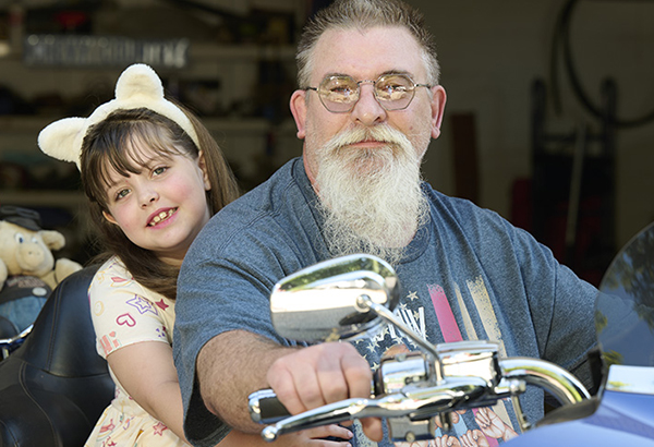 William is back to playing with his grandchildren and riding his motorcycle