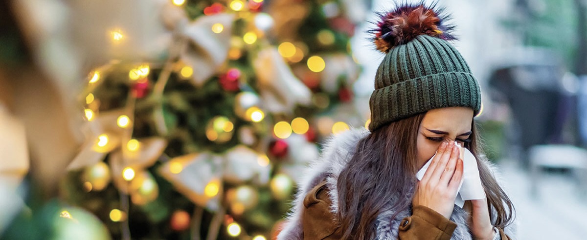 Woman blowing her nose during the holidays. 