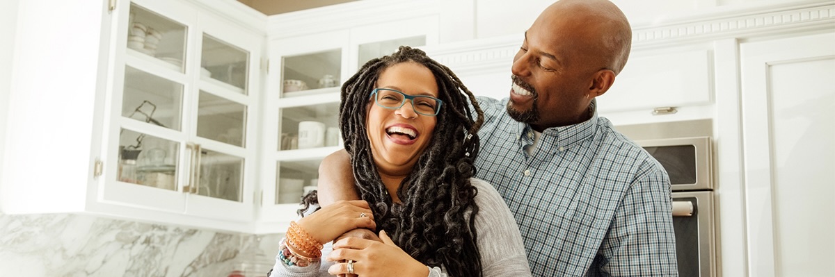 Man and woman smiling and hugging