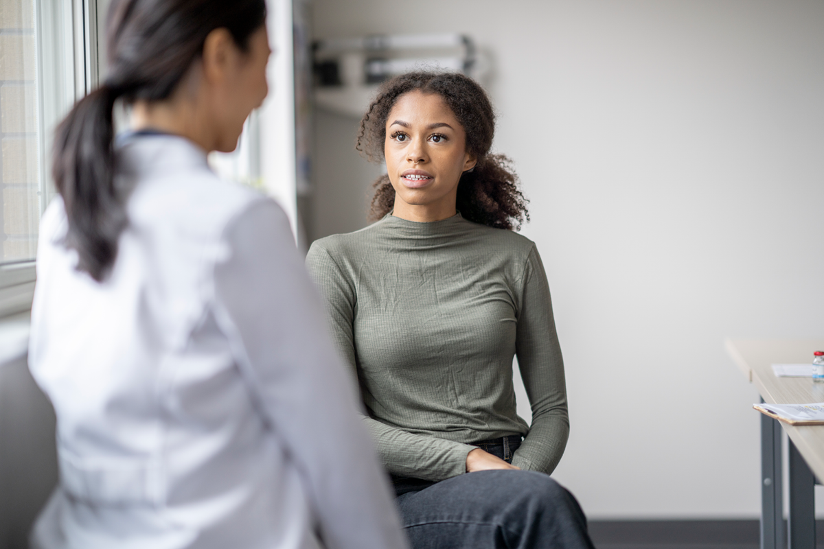 Young adult female patient interacting with primary care provider