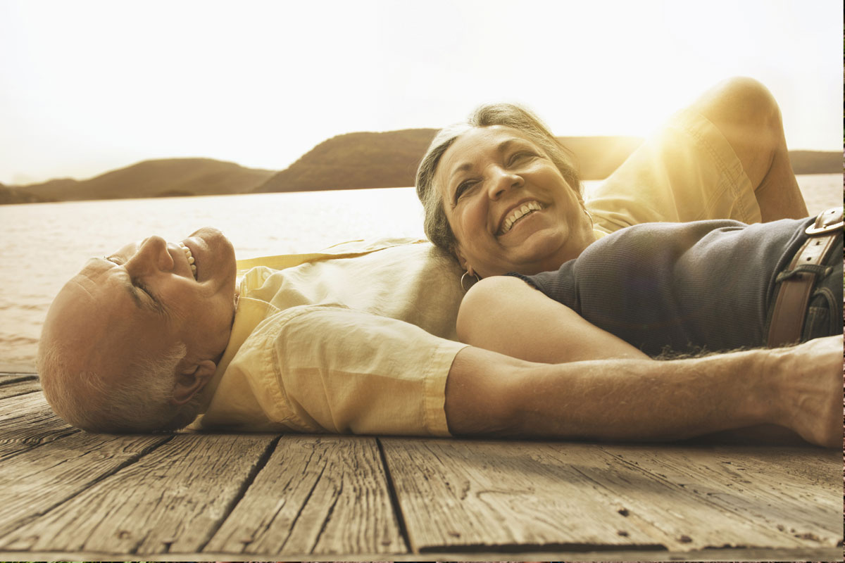 Woman and man laying outside next to each other