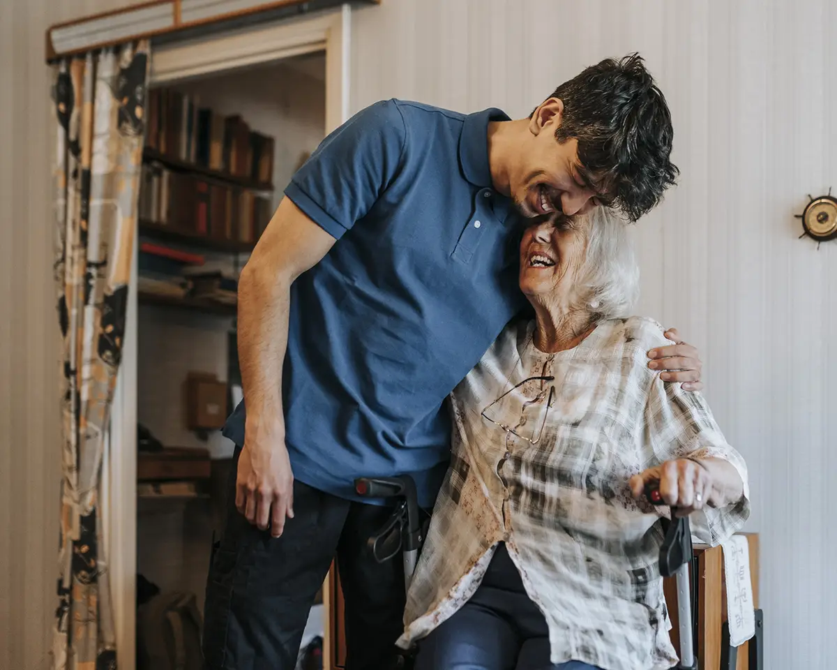 Man hugging a senior woman