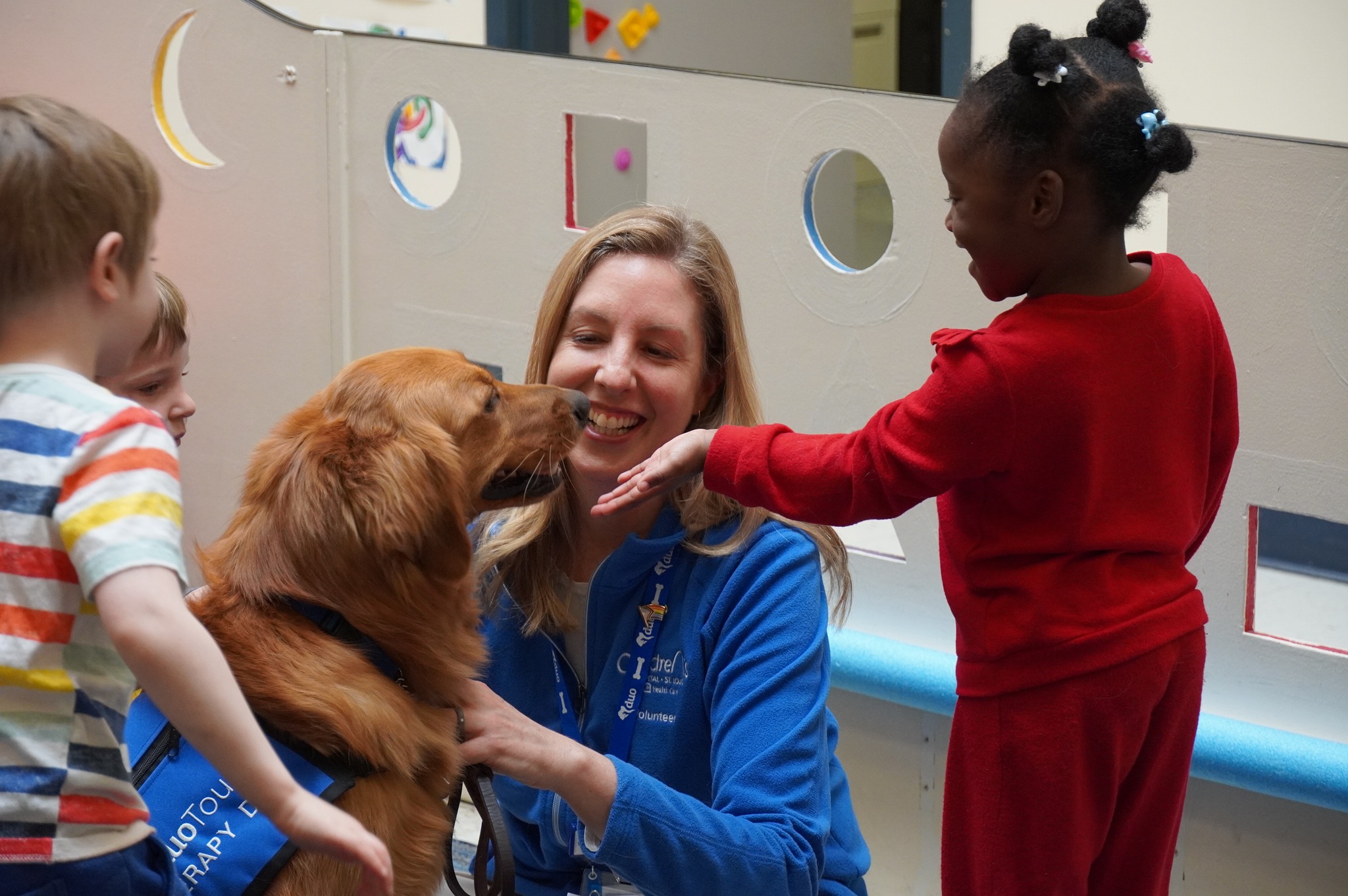 Therapist and children with dog