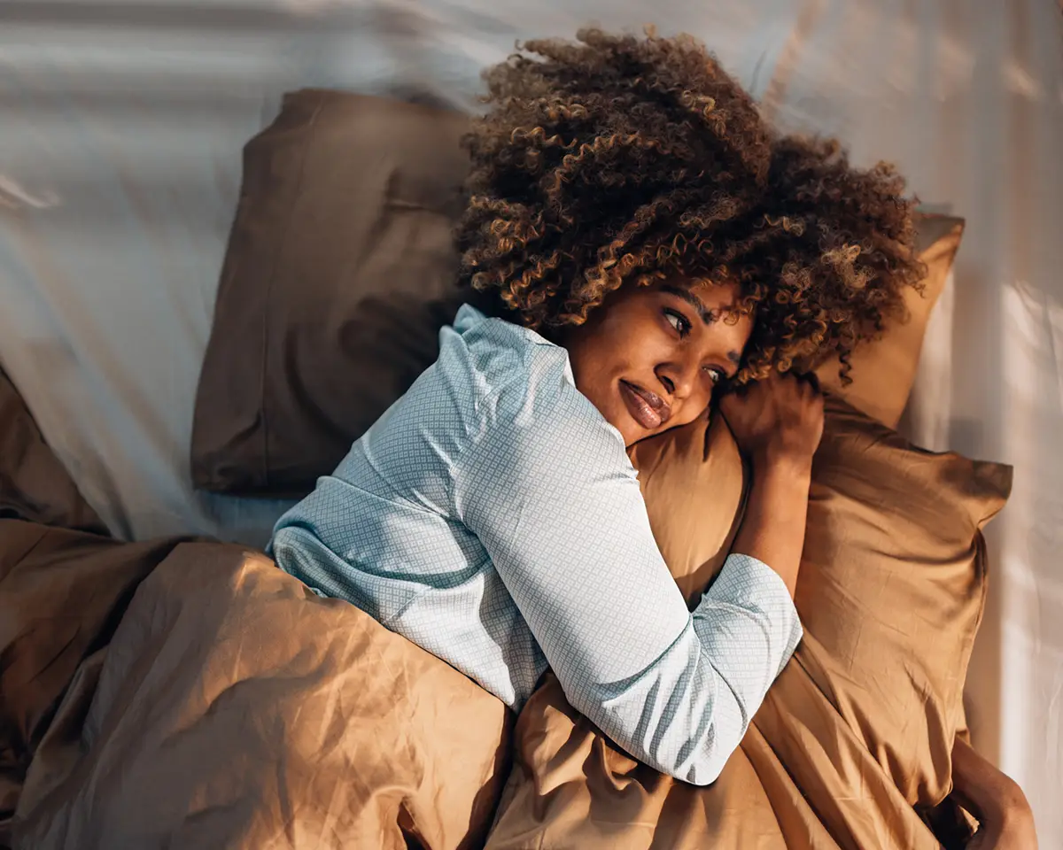 Woman with head on pillow