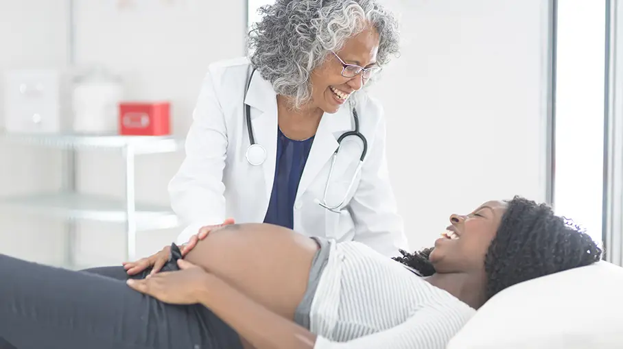 Woman doctor checking a pregnant woman