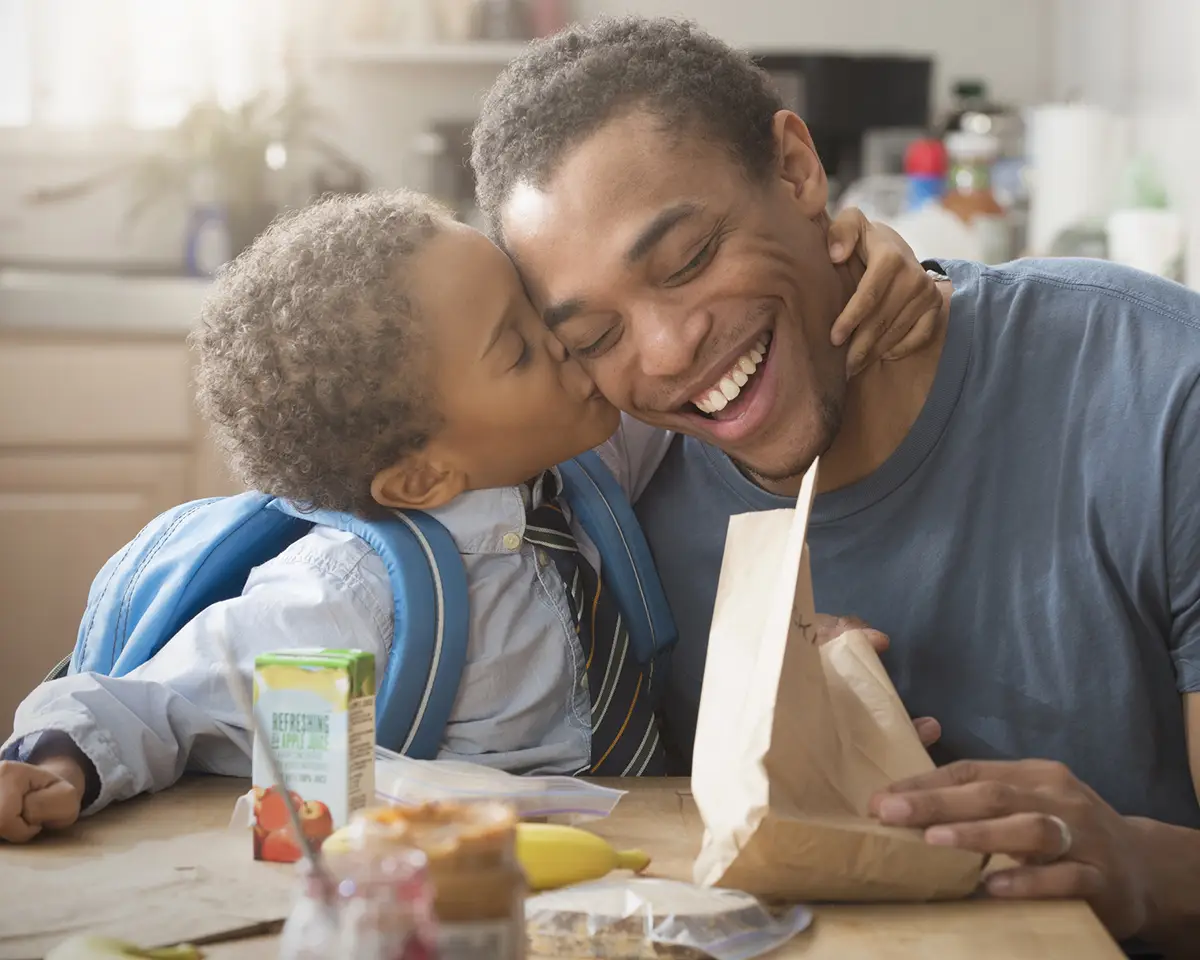 Father and son preparing lunch for school