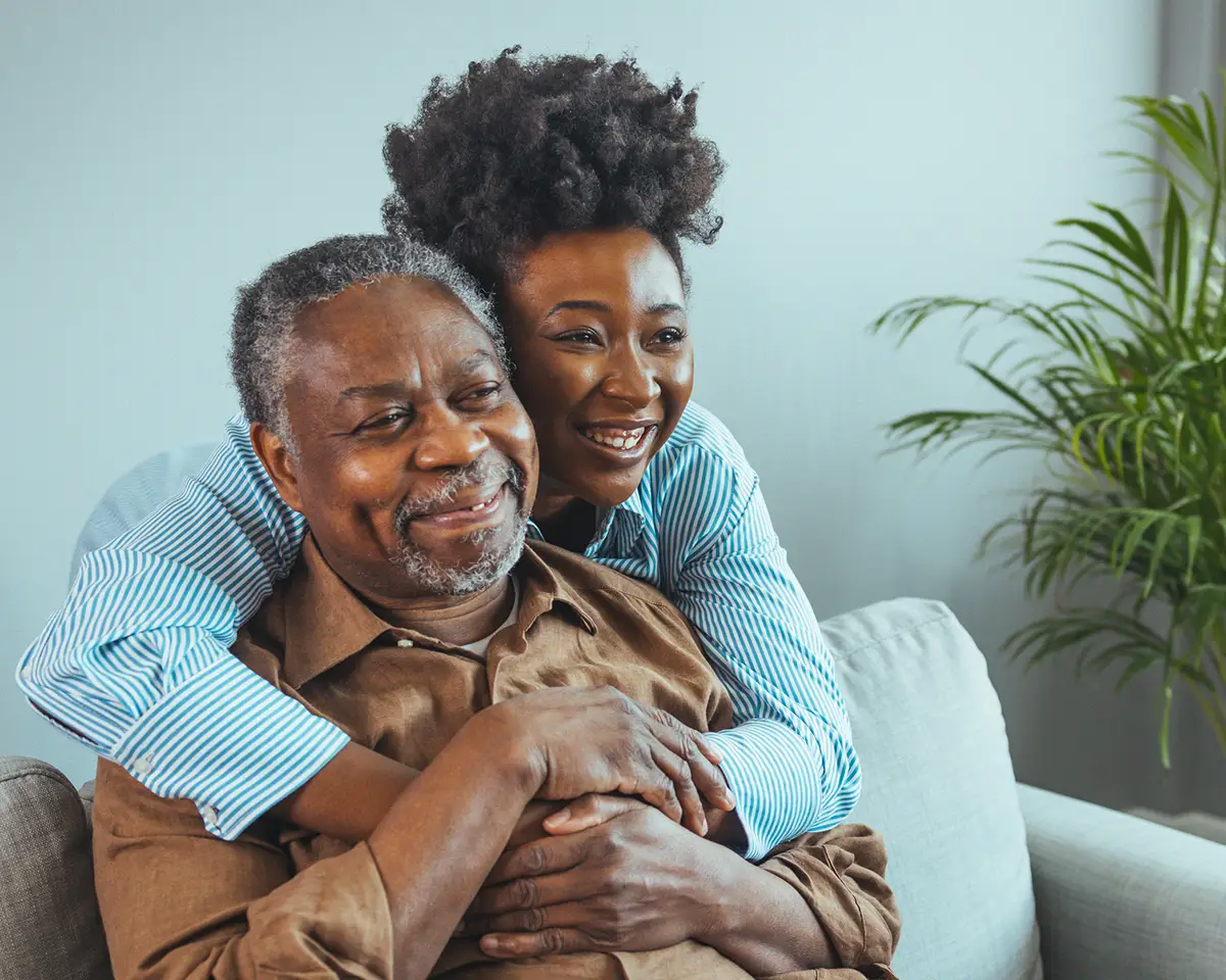 Woman and man smiling and hugging each other