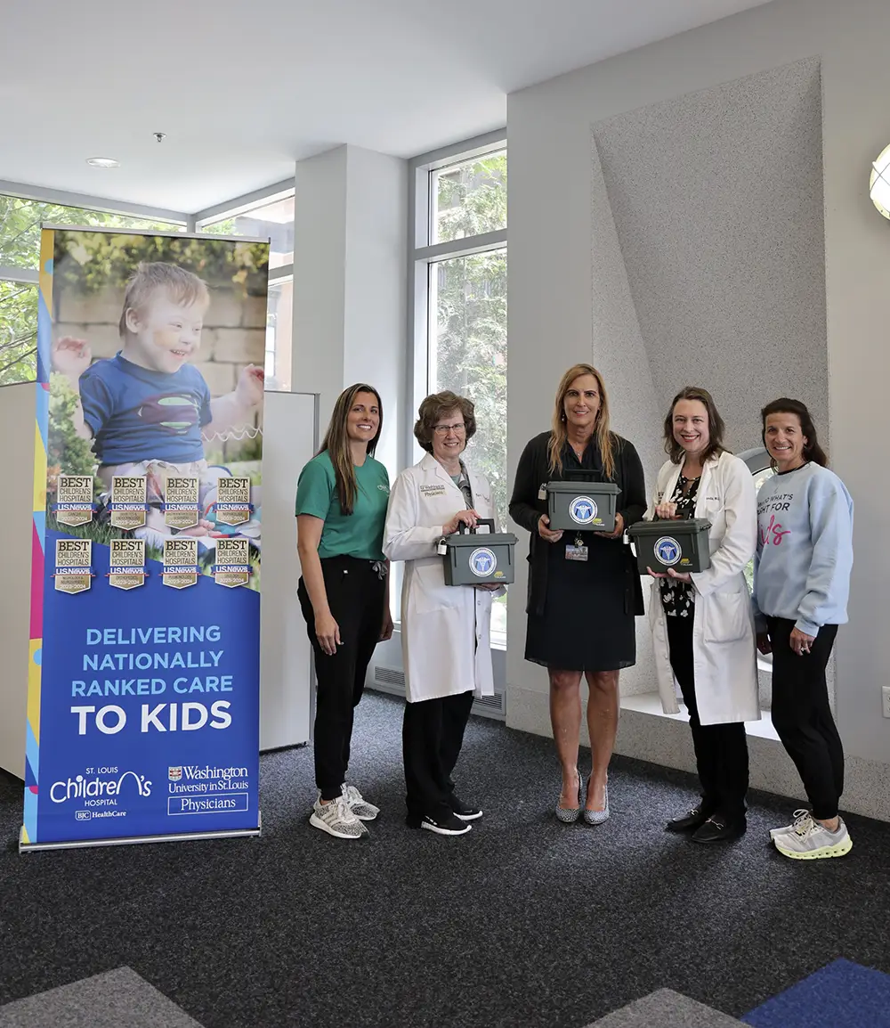 Medication lockboxes being presented by a group of people