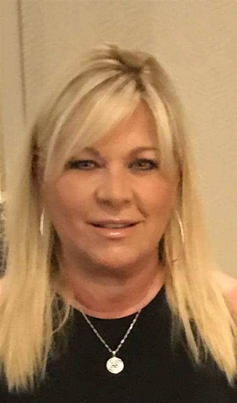 Headshot of patient Karen, 63, with straight, blonde hair and black sleeveless shirt