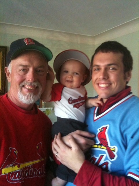 Dr. Ben Voss (right) holding baby son, posing with his father 