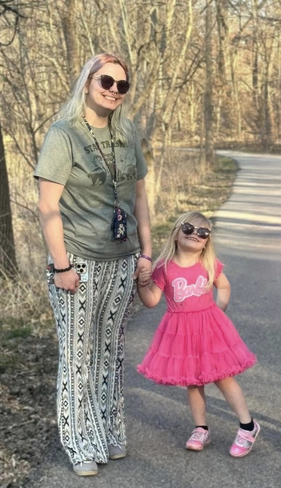 Anna and daughter standing near a wooded trail