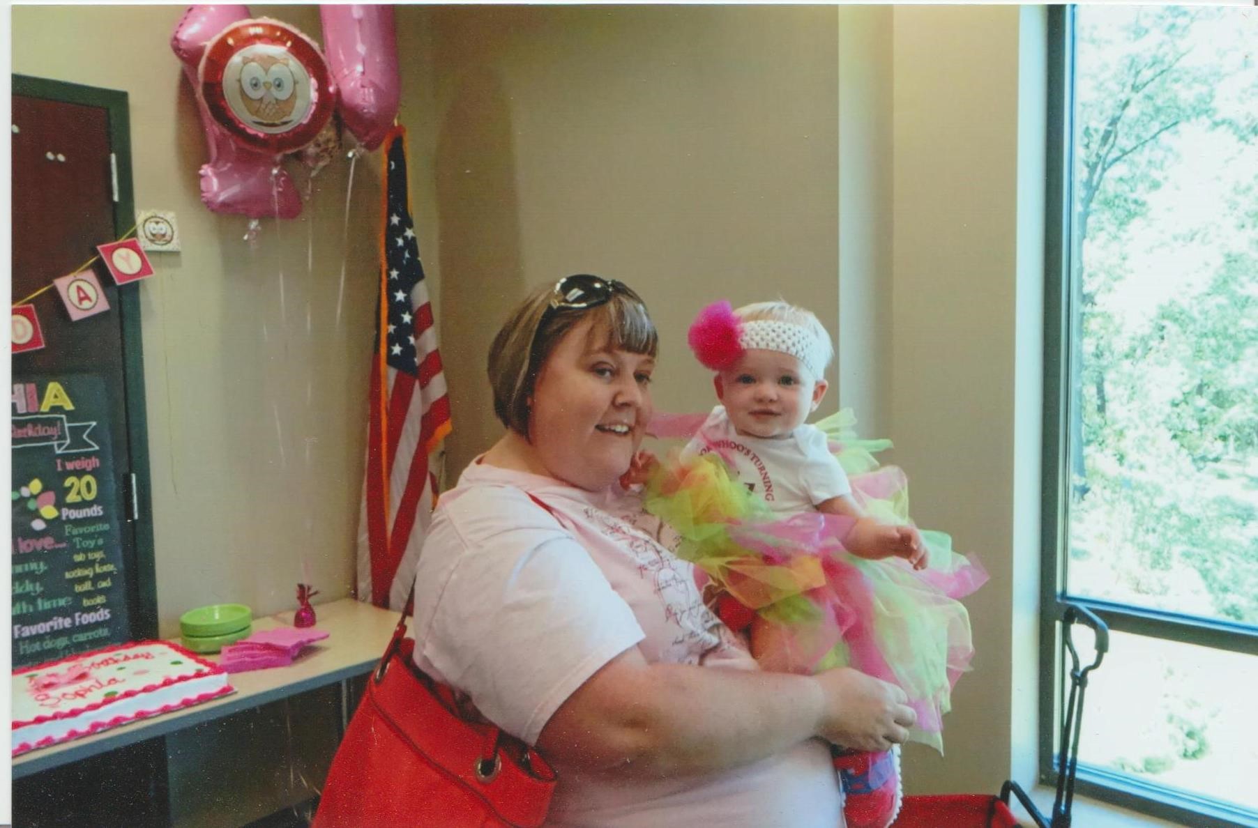 Patient Heather Taylor holding a baby smiling