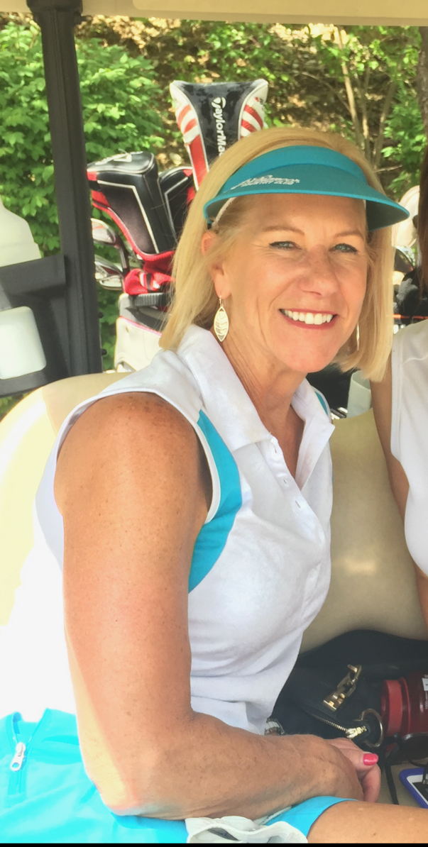 Half bodyshot of Barb Mitchell in teal cap and white and blue atheltic shirt and skirt