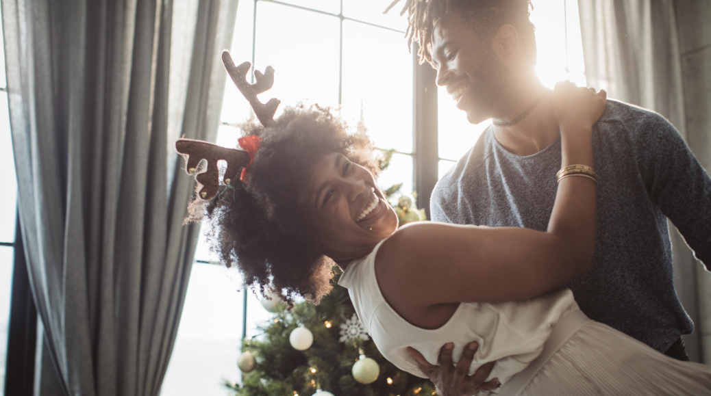 Two people dancing together at a holiday party