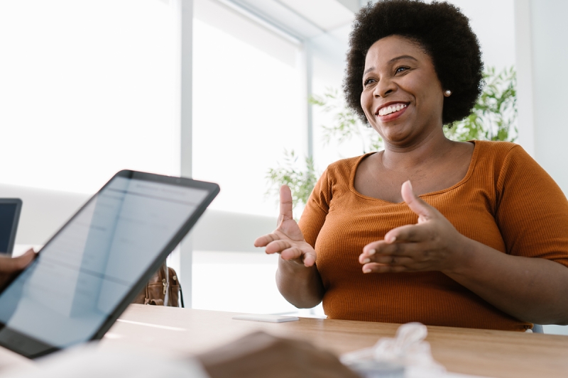 Woman sitting at a desk with a doctor