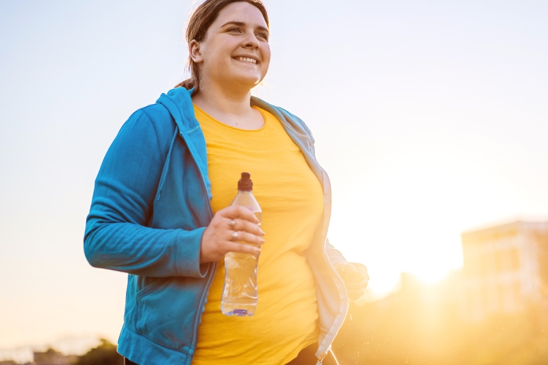 Woman working out and holding a water bottle